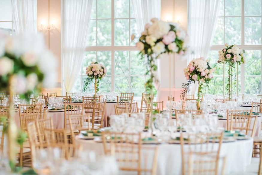 Questions to ask wedding venue: elegant wedding reception table arrangement with pink and white floral centerpieces